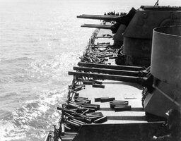 Guns_and_shell_casings_on_board_USS_Brooklyn_(CL-40)_during_Sicily_invasion,_July_1943.jpg