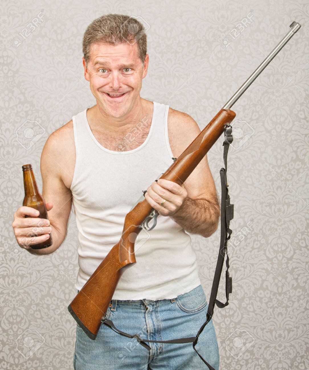 23050420-Single-male-hillbilly-holding-beer-and-rifle-Stock-Photo-redneck.jpg